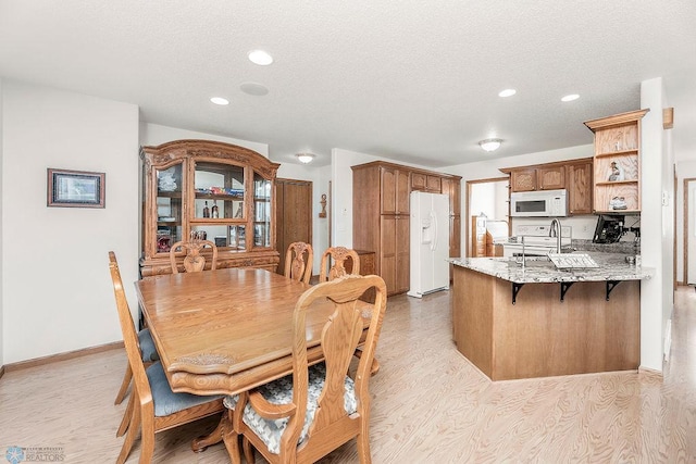 3358 70th Ave N, Moorhead, MN 56560 - dining area featuring light wood-type flooring, recessed lighting, and a textured ceiling