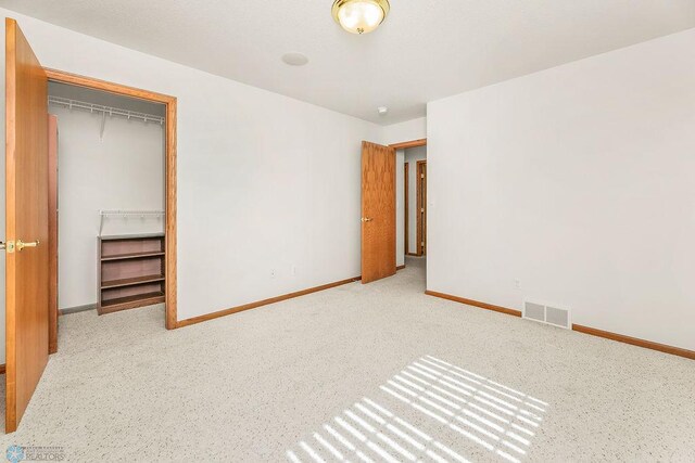 3358 70th Ave N, Moorhead, MN 56560 - unfurnished bedroom with baseboards and a closet