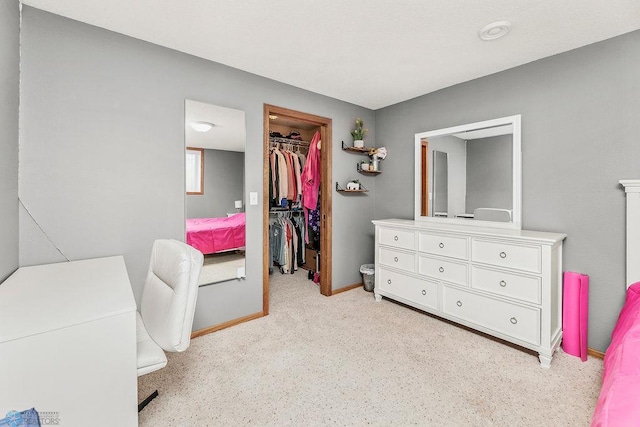 3358 70th Ave N, Moorhead, MN 56560 - bedroom with a spacious closet, a closet, baseboards, and light colored carpet