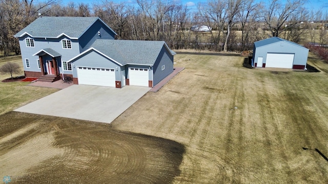 3358 70th Ave N, Moorhead, MN 56560 - view of front facade with concrete driveway, a front yard, roof with shingles, and an attached garage