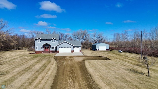 3358 70th Ave N, Moorhead, MN 56560 - view of front of house featuring driveway, a front lawn, and an outdoor structure