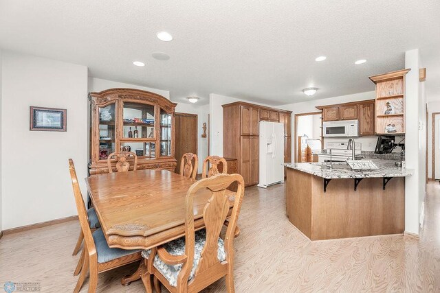 3358 70th Ave N, Moorhead, MN 56560 - dining space featuring light wood-type flooring, recessed lighting, and a textured ceiling