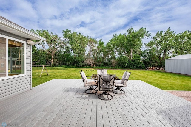 3358 70th Ave N, Moorhead, MN 56560 - deck with a yard, outdoor dining space, and view of wooded area