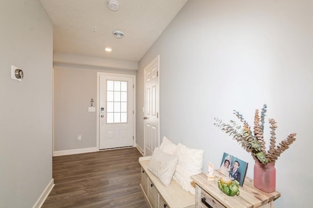 doorway featuring recessed lighting, baseboards, and dark wood-style flooring