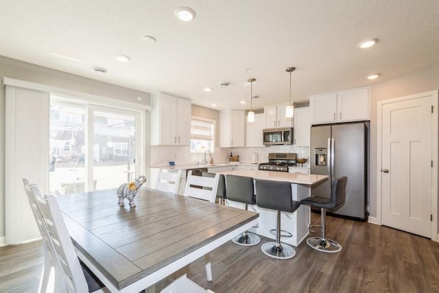 dining room with dark wood-style floors and recessed lighting