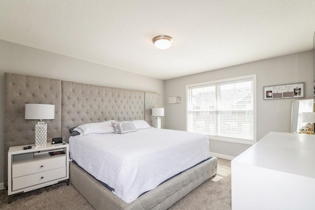 carpeted bedroom featuring baseboards