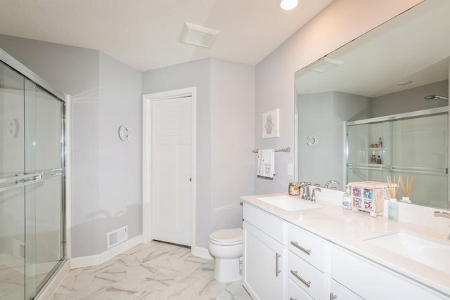 full bathroom featuring a shower stall, toilet, and a sink