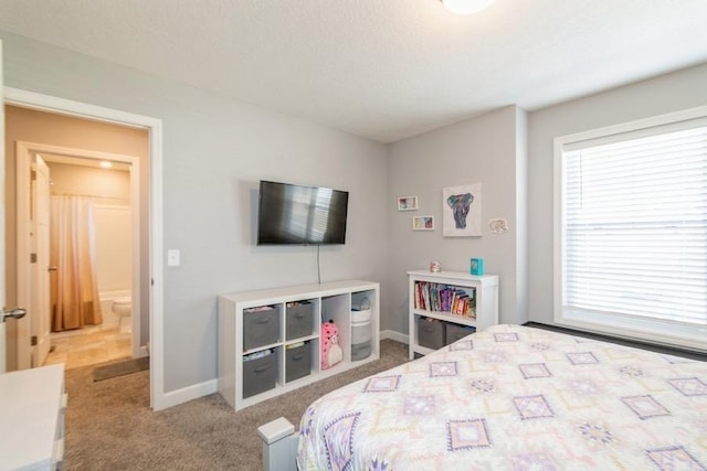 bedroom with baseboards, carpet flooring, and multiple windows