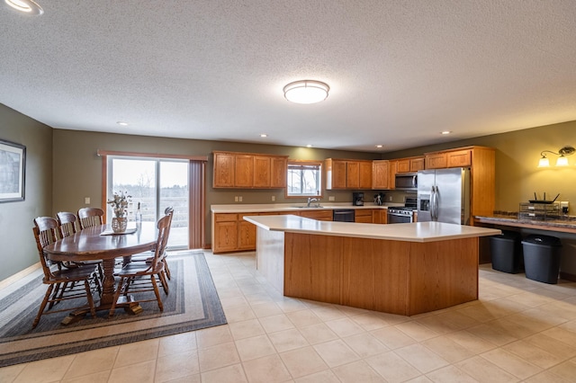 34506 Pleasant Point Dr, Homer Twp, MN 55987 - kitchen with appliances with stainless steel finishes, light countertops, a center island, a sink, and a textured ceiling