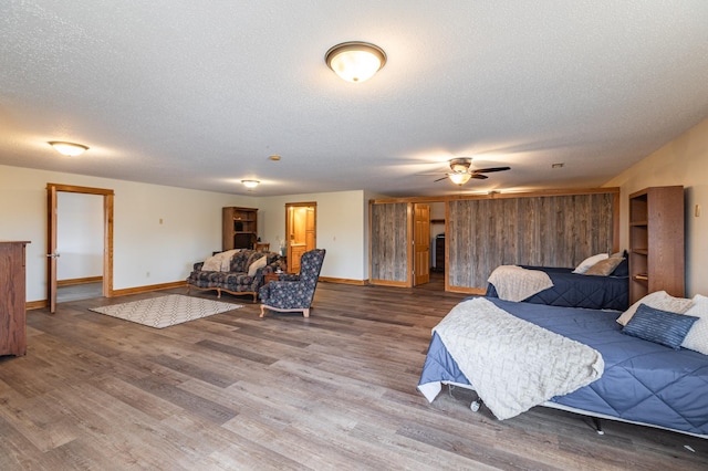 34506 Pleasant Point Dr, Homer Twp, MN 55987 - bedroom with a textured ceiling, baseboards, wood finished floors, and ceiling fan