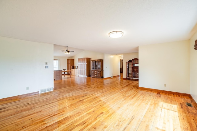 34506 Pleasant Point Dr, Homer Twp, MN 55987 - unfurnished living room featuring light wood-style flooring, baseboards, a ceiling fan, and vaulted ceiling