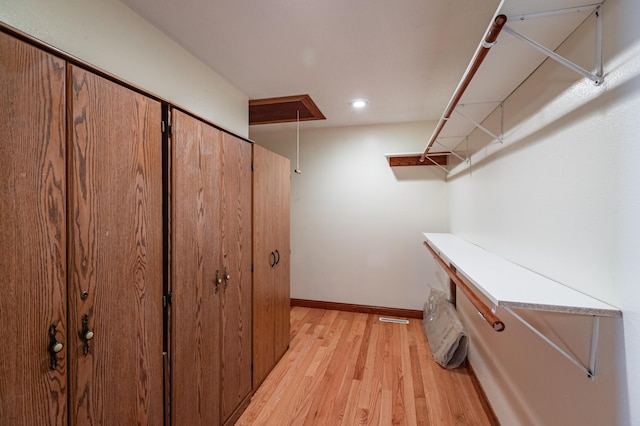 34506 Pleasant Point Dr, Homer Twp, MN 55987 - walk in closet featuring attic access and light wood-style flooring