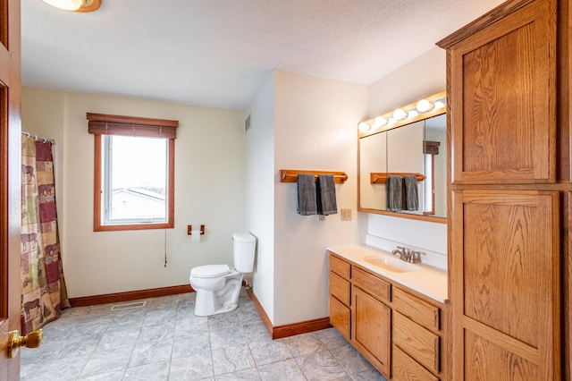 34506 Pleasant Point Dr, Homer Twp, MN 55987 - bathroom featuring toilet, baseboards, and vanity