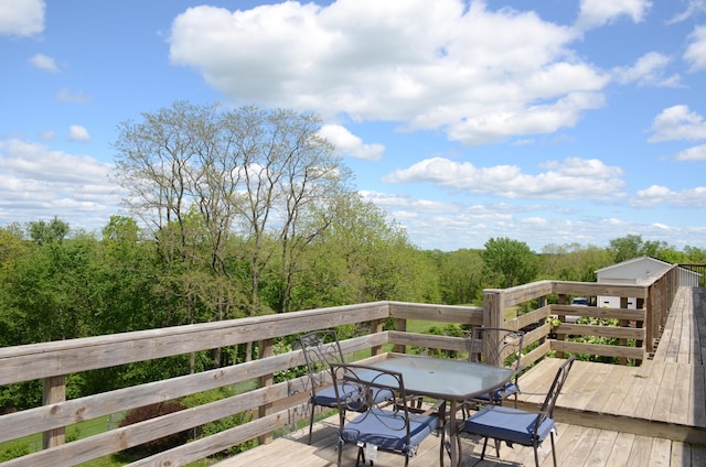 34506 Pleasant Point Dr, Homer Twp, MN 55987 - wooden terrace with outdoor dining area and a view of trees