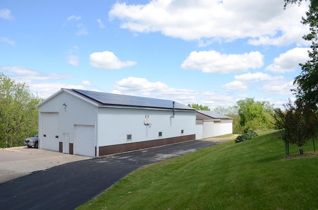 34506 Pleasant Point Dr, Homer Twp, MN 55987 - view of property exterior with a garage, a yard, and an outbuilding
