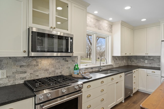 4767 Lake Ave, White Bear Lake, MN 55110 - kitchen featuring stainless steel appliances, a sink, dark wood-style floors, dark countertops, and glass insert cabinets