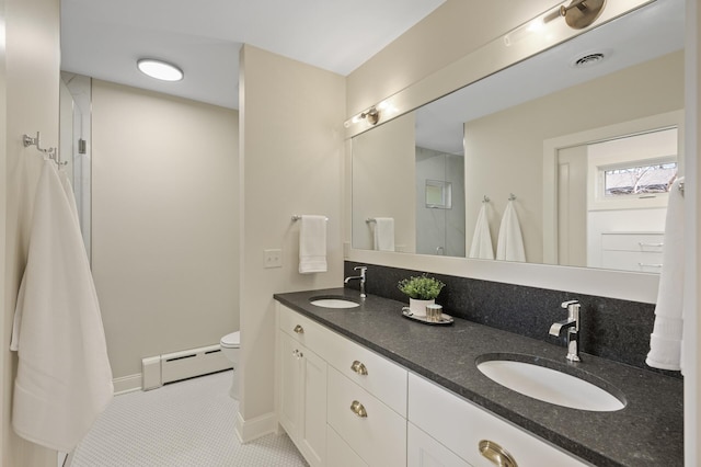 4767 Lake Ave, White Bear Lake, MN 55110 - bathroom with a baseboard heating unit, toilet, tile patterned floors, double vanity, and baseboards