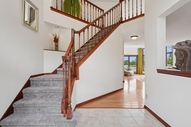 19826 Dakota Ave, Prior Lake, MN 55372 - stairs featuring baseboards, tile patterned floors, and a towering ceiling