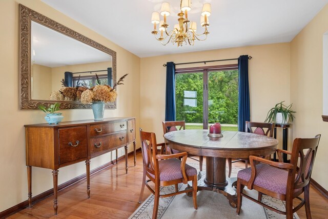 19826 Dakota Ave, Prior Lake, MN 55372 - dining space featuring wood finished floors, a chandelier, and baseboards