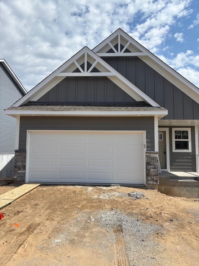 1591 76th St W, Inver Grove Heights, MN 55077 - craftsman-style home with stone siding, board and batten siding, and driveway
