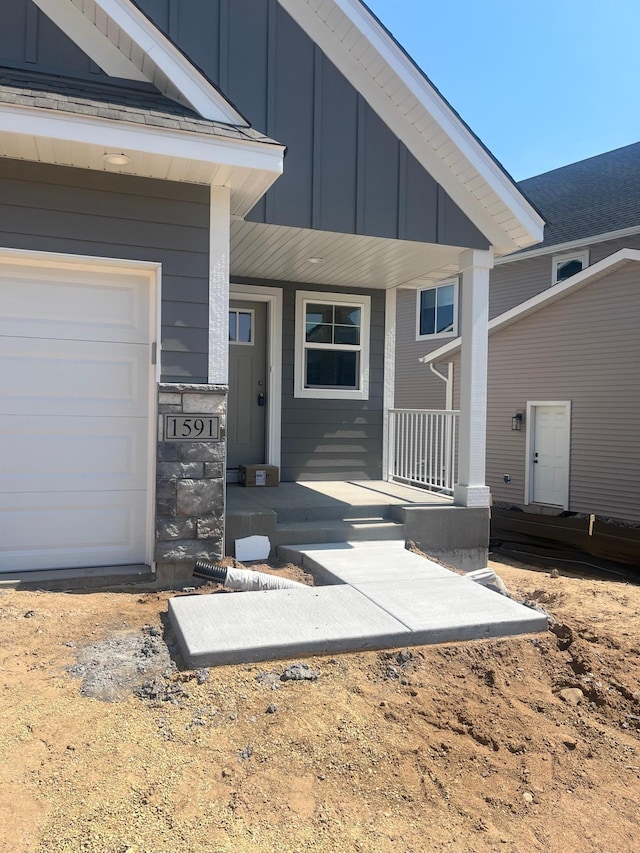 1591 76th St W, Inver Grove Heights, MN 55077 - view of exterior entry featuring a porch and board and batten siding