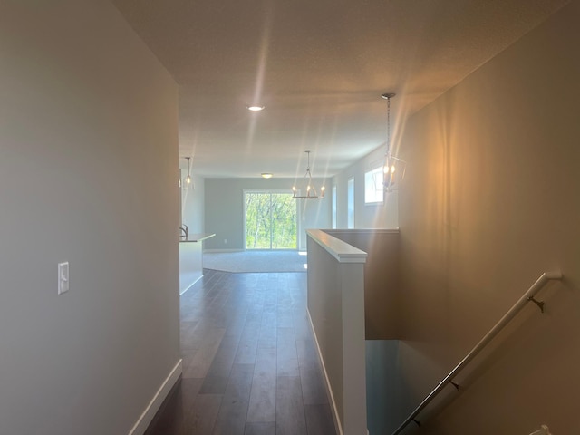 1591 76th St W, Inver Grove Heights, MN 55077 - corridor with a chandelier, baseboards, dark wood finished floors, and an upstairs landing