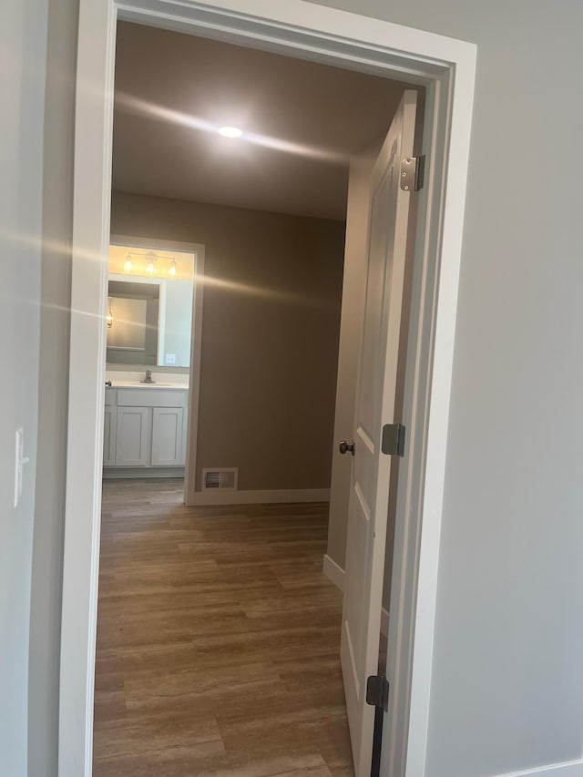 1591 76th St W, Inver Grove Heights, MN 55077 - corridor featuring wood finished floors, baseboards, and a sink