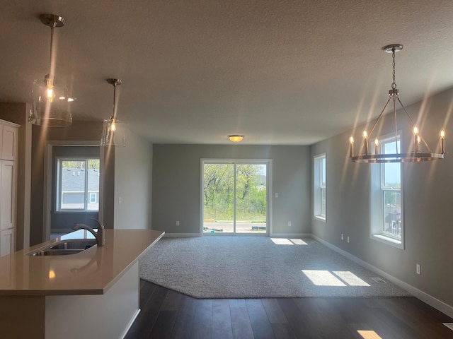 1591 76th St W, Inver Grove Heights, MN 55077 - kitchen with a sink, a chandelier, dark wood-type flooring, open floor plan, and a textured ceiling