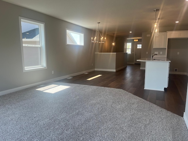 1591 76th St W, Inver Grove Heights, MN 55077 - kitchen with baseboards, light countertops, open floor plan, white cabinets, and recessed lighting