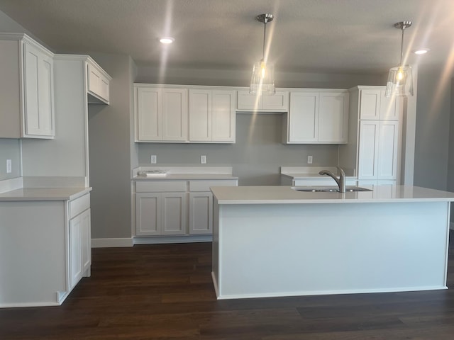 1591 76th St W, Inver Grove Heights, MN 55077 - kitchen featuring a sink, an island with sink, dark wood finished floors, white cabinetry, and recessed lighting