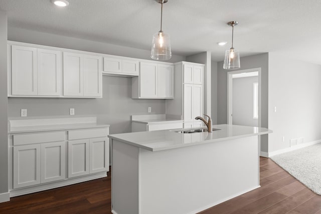 1591 76th St W, Inver Grove Heights, MN 55077 - kitchen with a sink, dark wood-type flooring, white cabinetry, a center island with sink, and hanging light fixtures