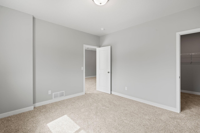 1591 76th St W, Inver Grove Heights, MN 55077 - unfurnished bedroom with carpet, a spacious closet, baseboards, and a closet