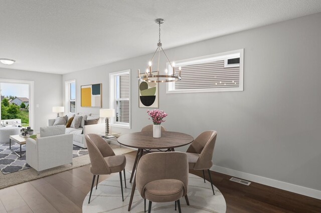 1591 76th St W, Inver Grove Heights, MN 55077 - dining space with a chandelier, plenty of natural light, and wood finished floors