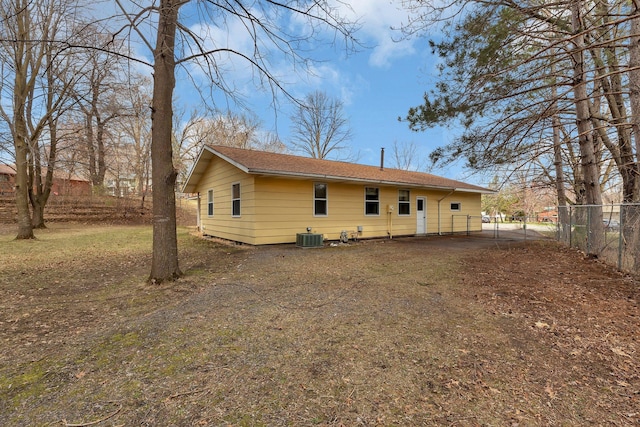 rear view of house with fence and cooling unit