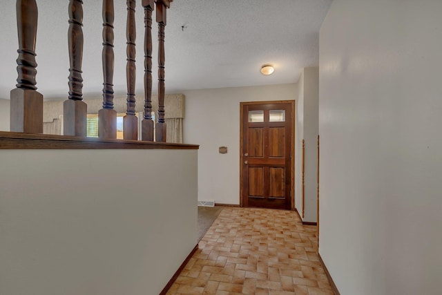 interior space with baseboards, brick floor, and visible vents