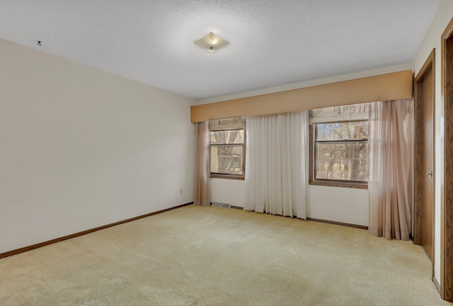 unfurnished room featuring baseboards, carpet flooring, and visible vents