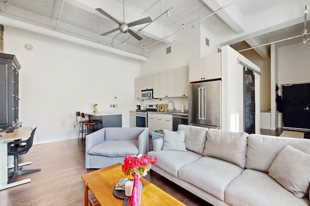 700 Washington Ave N Unit 617, Minneapolis, MN 55401 - living room featuring visible vents, ceiling fan, wood finished floors, and a towering ceiling