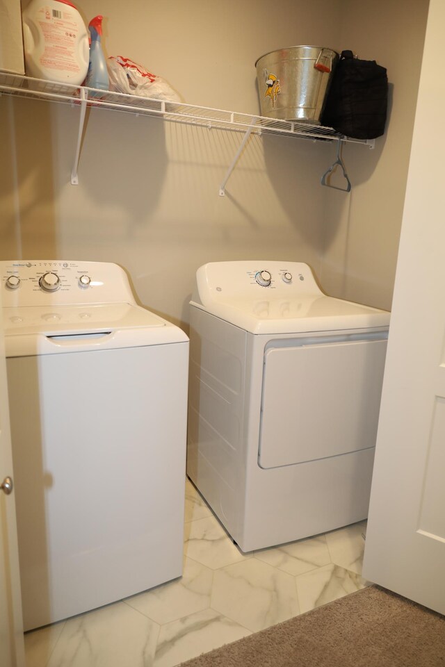 washroom with laundry area, marble finish floor, and washer and dryer