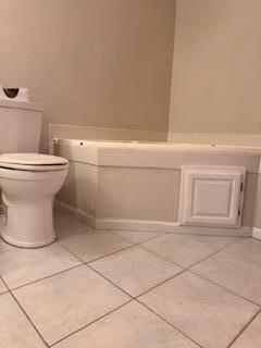 bathroom with toilet and tile patterned floors