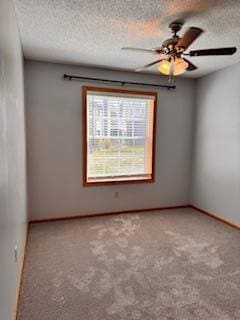 spare room with a textured ceiling, ceiling fan, and carpet floors