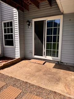 property entrance with a patio area