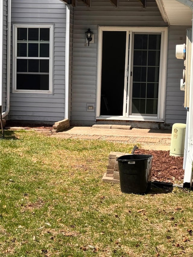 entrance to property with a yard