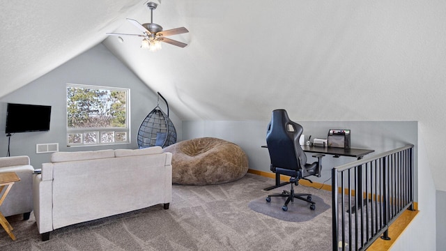 carpeted office featuring visible vents, ceiling fan, vaulted ceiling, and baseboards