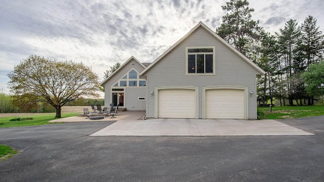 view of front facade featuring a garage and aphalt driveway