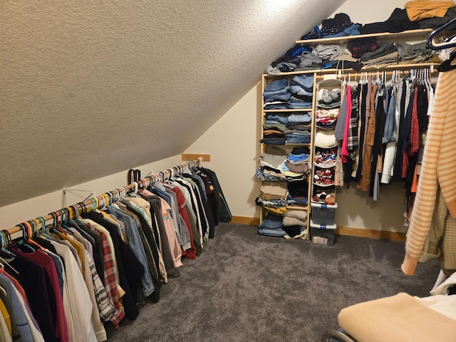 walk in closet featuring carpet and lofted ceiling