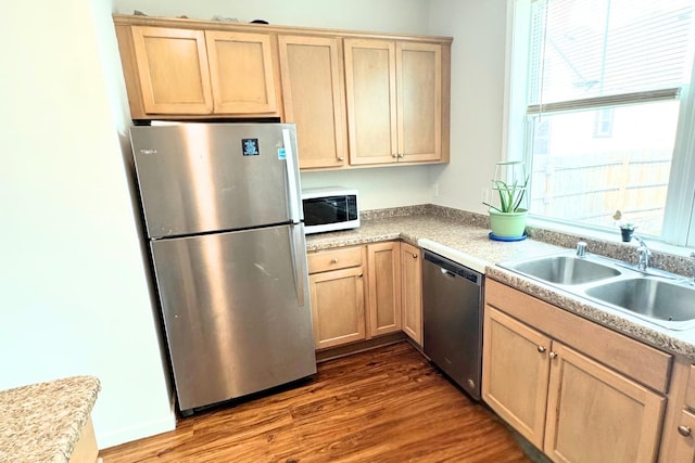 716 Desoto St, Saint Paul, MN 55130 - kitchen with dark wood finished floors, a sink, light countertops, light brown cabinets, and stainless steel appliances