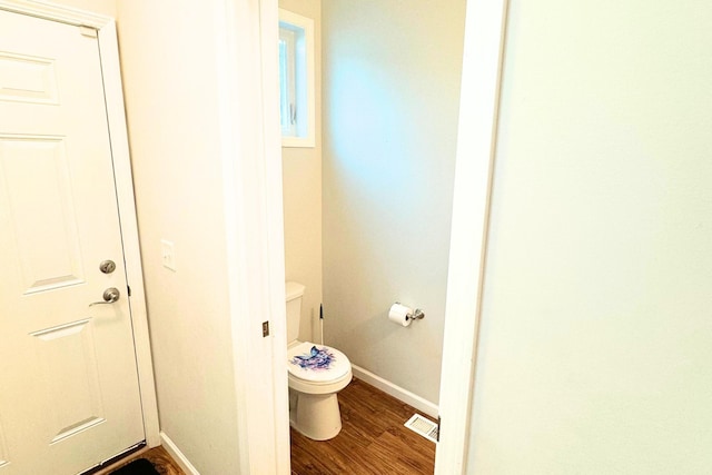 716 Desoto St, Saint Paul, MN 55130 - bathroom with baseboards, wood finished floors, visible vents, and toilet