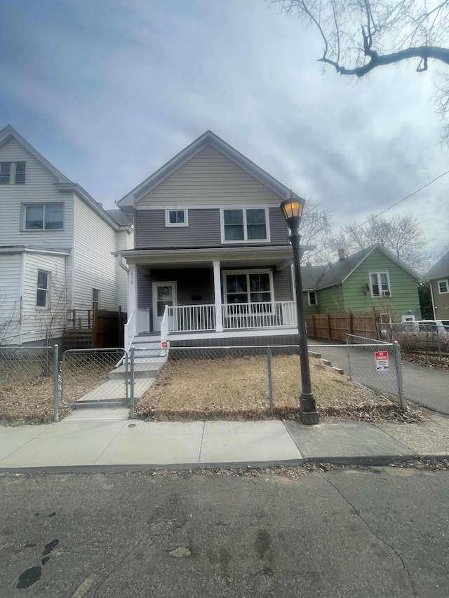 716 Desoto St, Saint Paul, MN 55130 - view of front of property with a porch, a fenced front yard, and a gate
