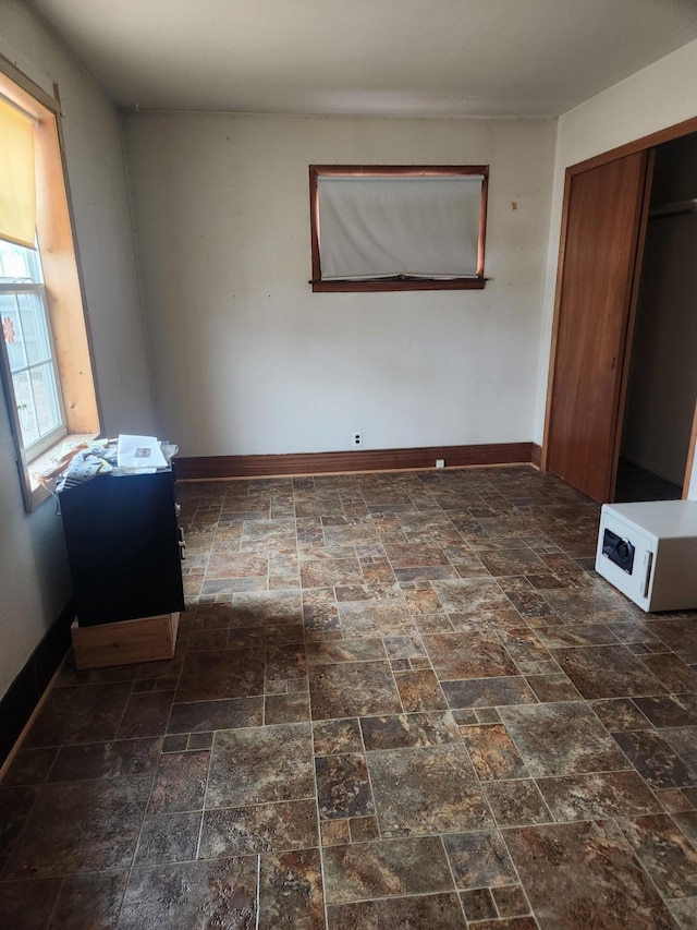 610 Grand Ave, Worthington, MN 56187 - unfurnished bedroom featuring baseboards and a closet