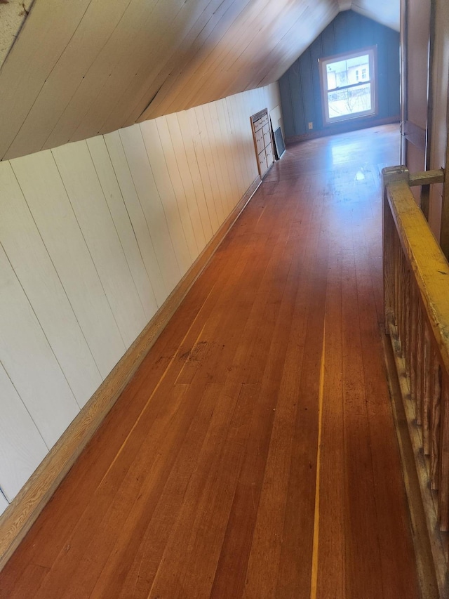 610 Grand Ave, Worthington, MN 56187 - additional living space featuring vaulted ceiling, hardwood / wood-style floors, and wooden walls